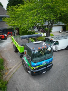 Aerial view of a disposal bin truck working a residential property in the Fraser Valley