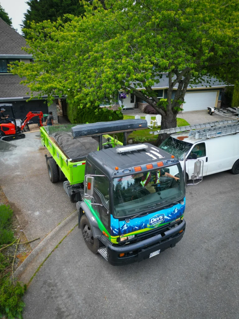 Aerial view of a disposal bin truck working a residential property in the Fraser Valley